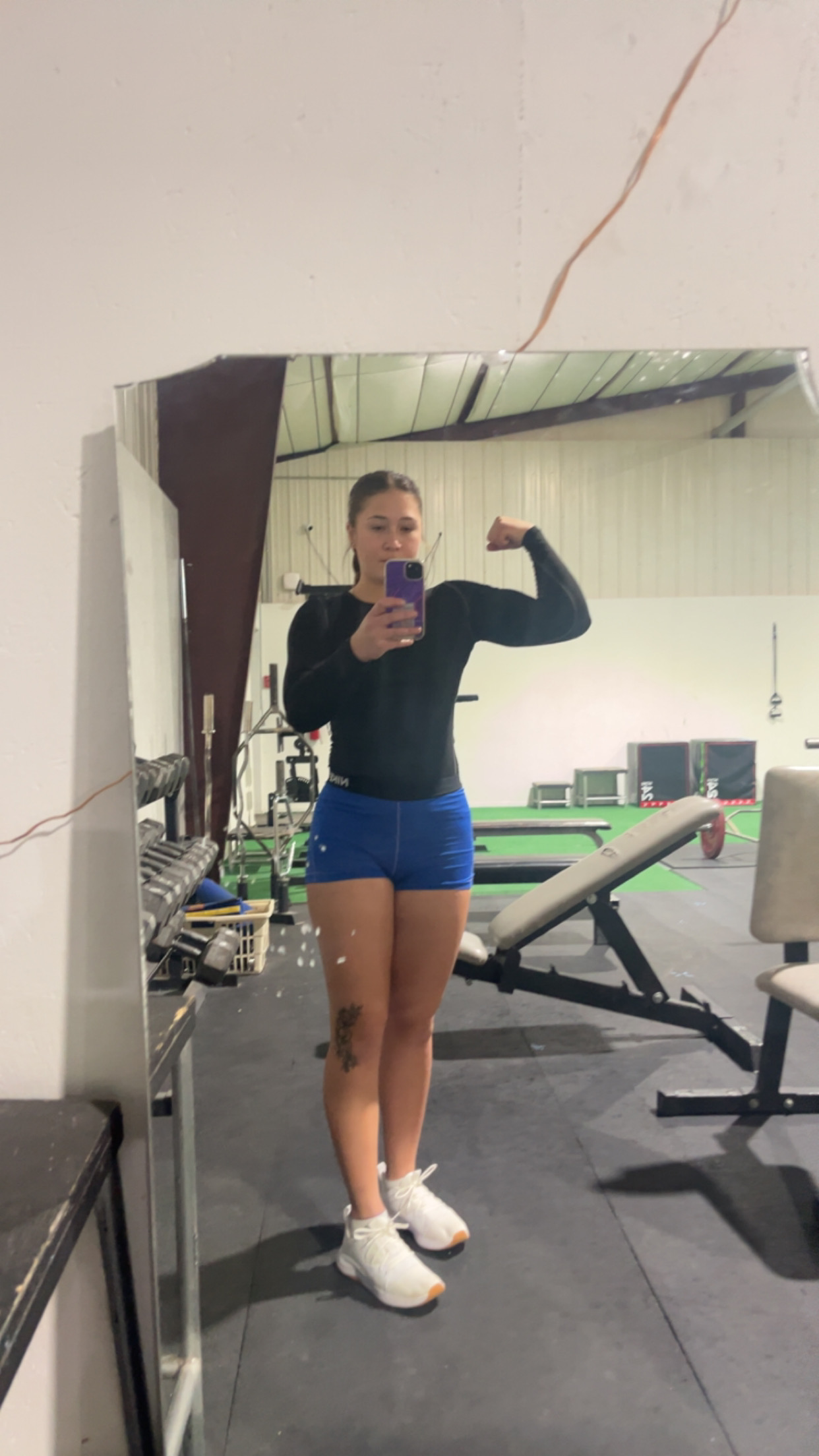 Rylee posing in a gym mirror after a session