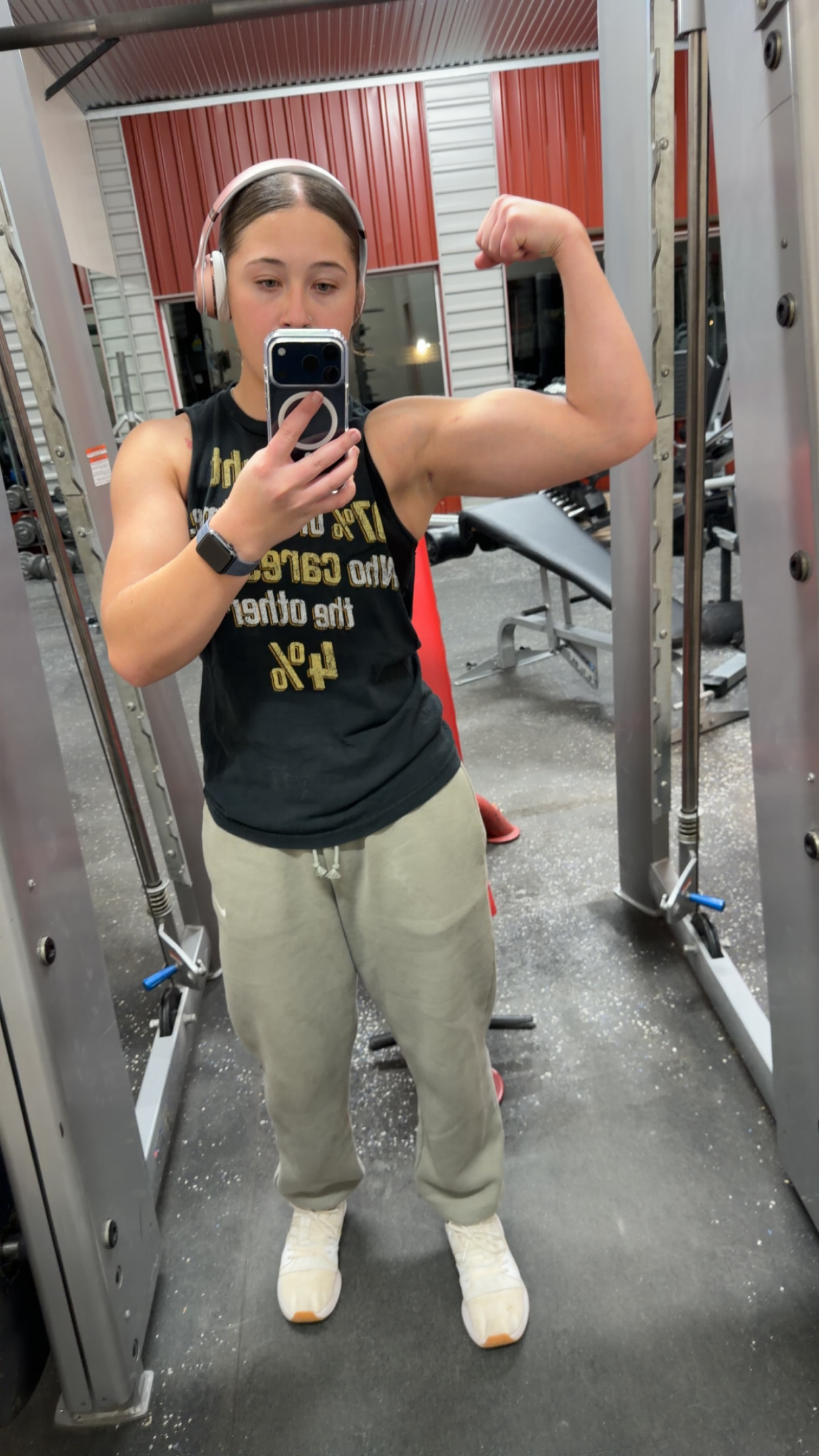 Rylee flexing in a gym mirror during a training session